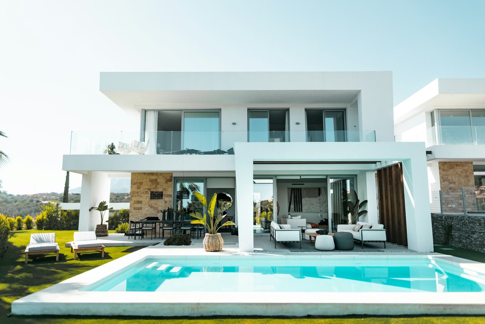A sunlit contemporary villa beside a turquoise pool